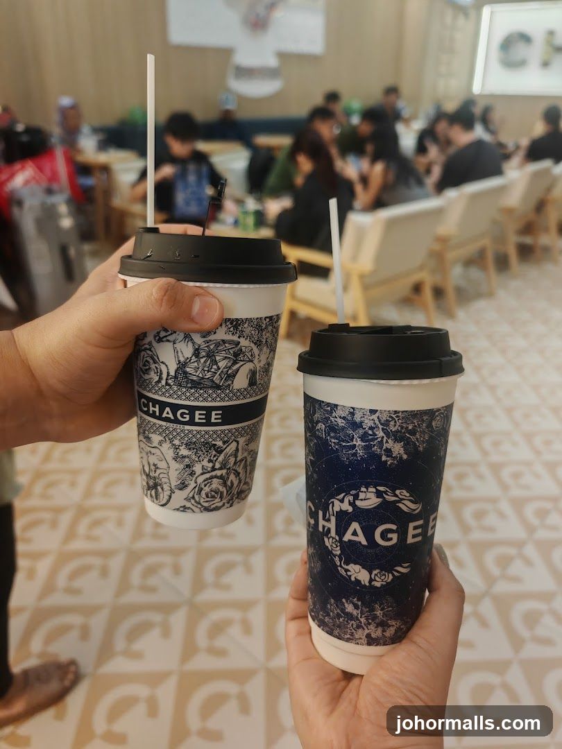 Two Chagee cups held in hands