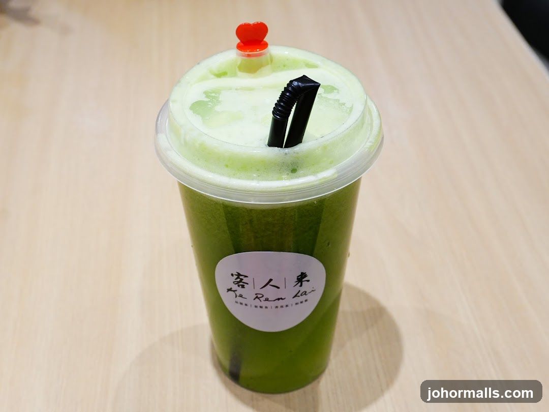 Green beverage in plastic cup