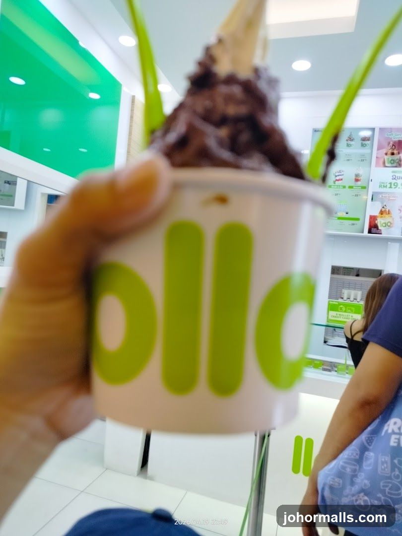 Hand holding ice cream cup in store