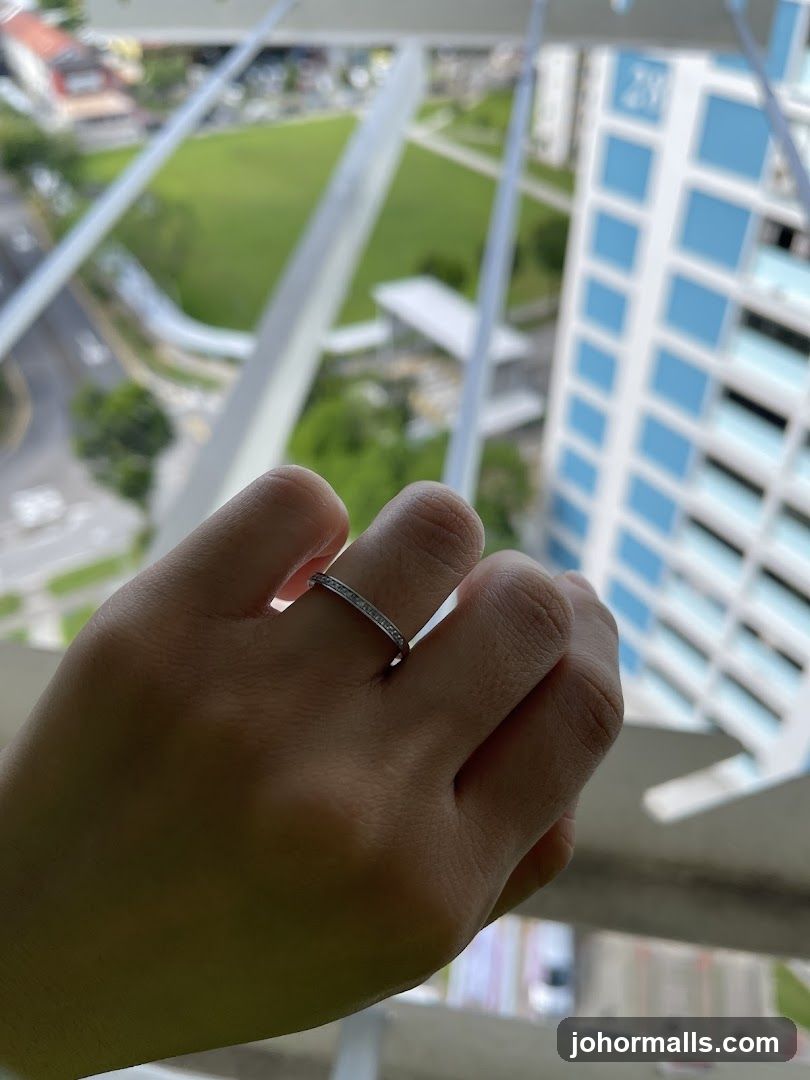 Hand with Ring Against Urban Background