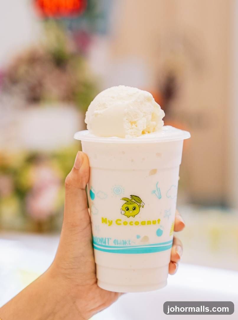 Hand holding a coconut shake cup