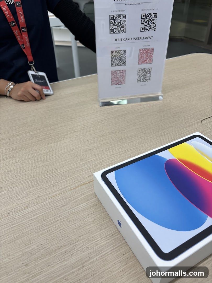Apple Product Display with Staff Member
