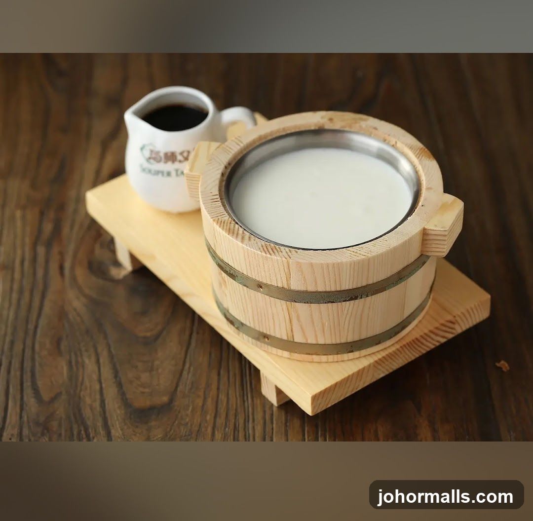 Wooden Bucket with Milk and Small Pitcher on Wooden Tray