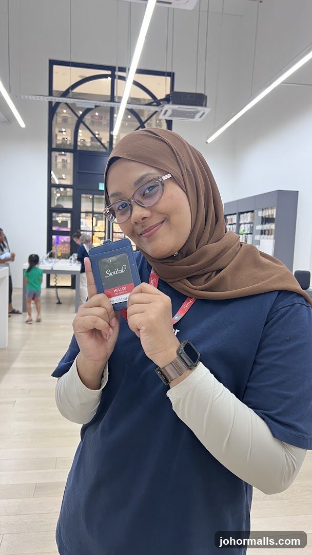 Staff Member Holding ID Badge