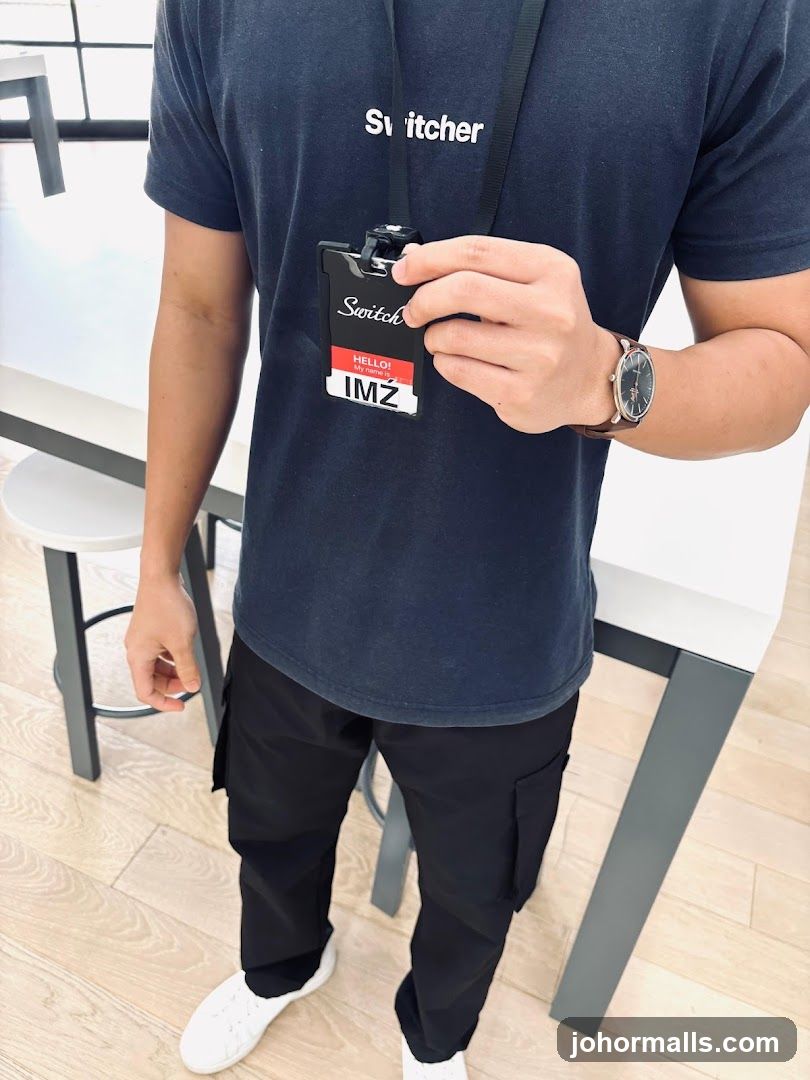 Staff Member Holding ID Badge