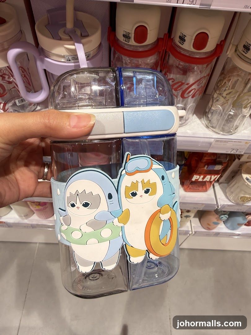 Hand holding a cartoon-themed water bottle in store aisle