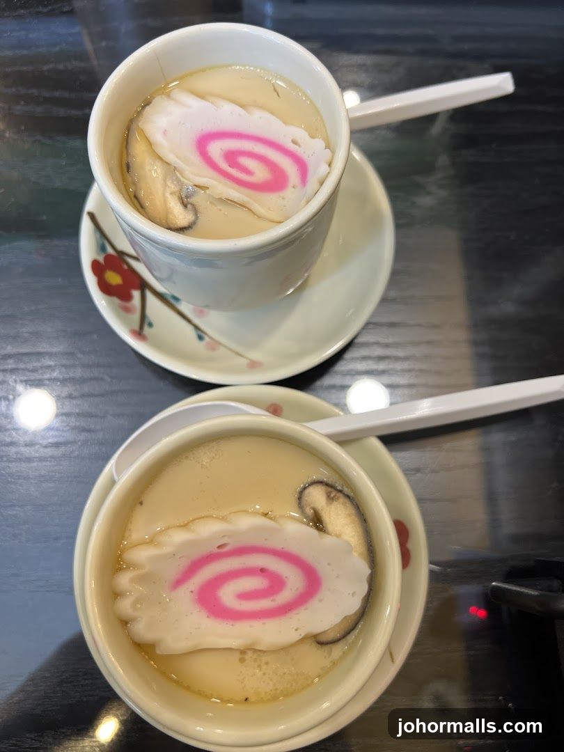 Two bowls of soup with decorative toppings