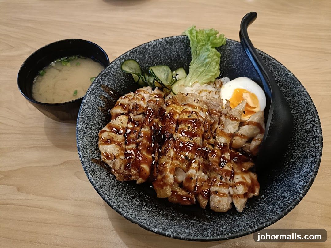 Bowl of Japanese-style rice dish with side of miso soup