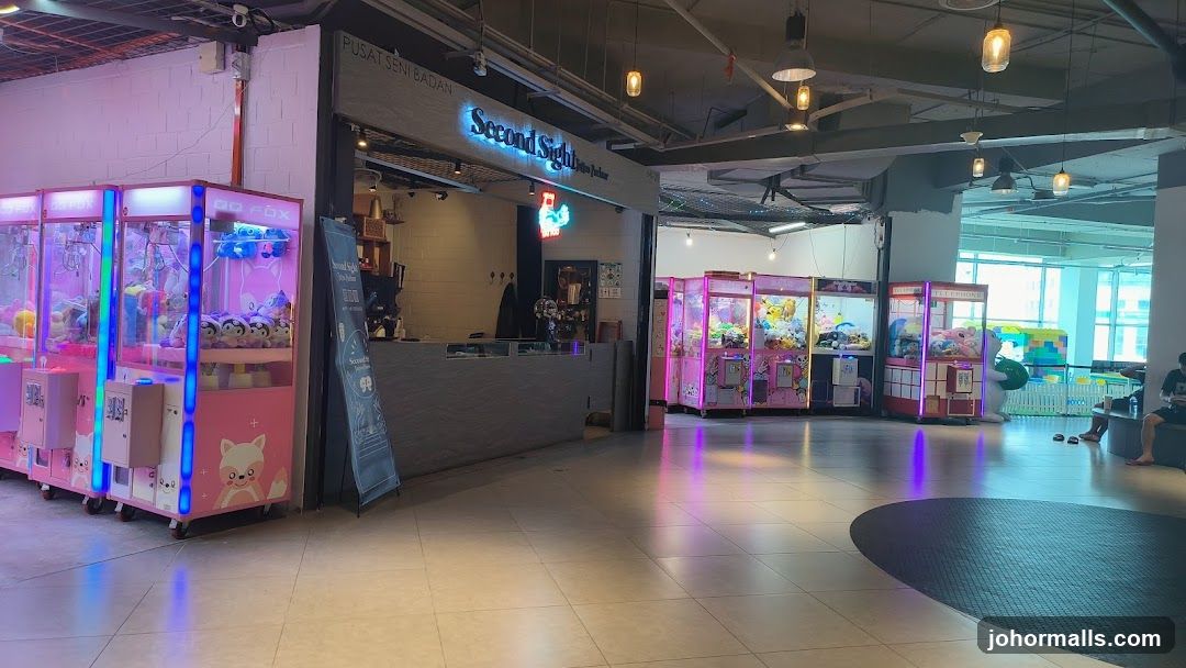 Interior of a shopping center with claw machines and storefront