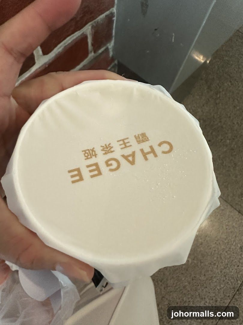 Hand holding branded cup lid