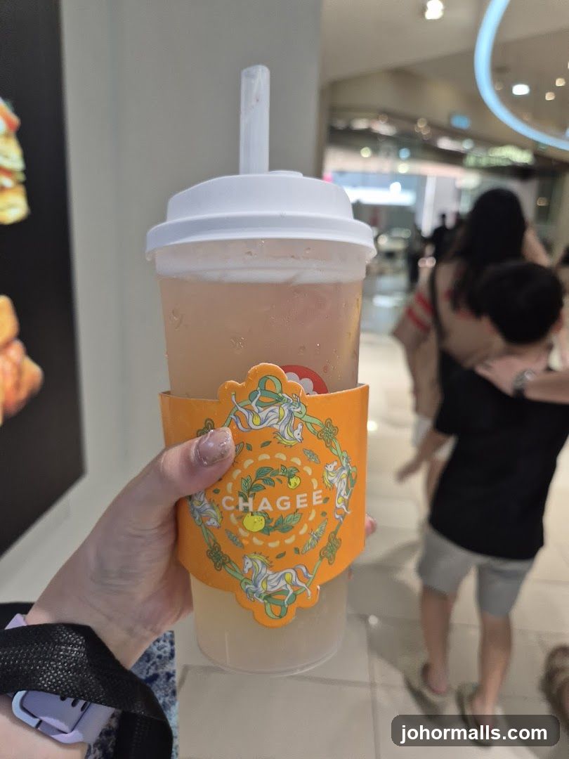 Hand holding beverage cup