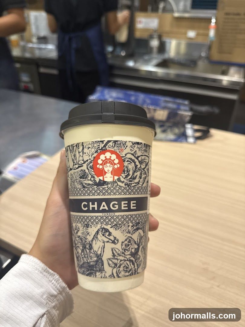 Hand holding Chagee drink