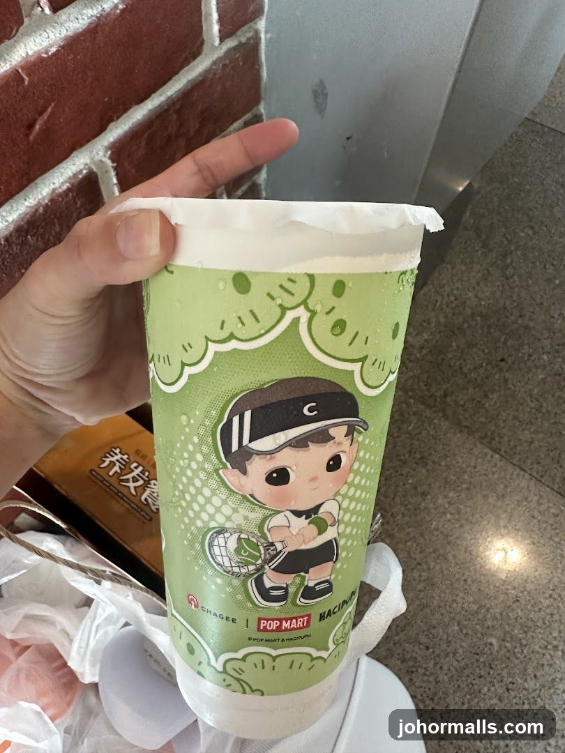 Hand holding a branded beverage cup