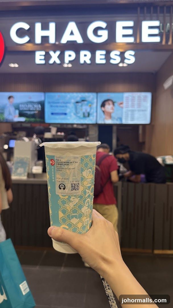Hand holding Chagee Express drink