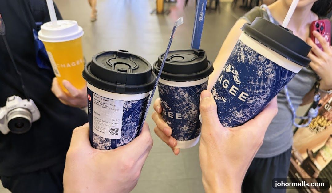 People holding beverages at a café