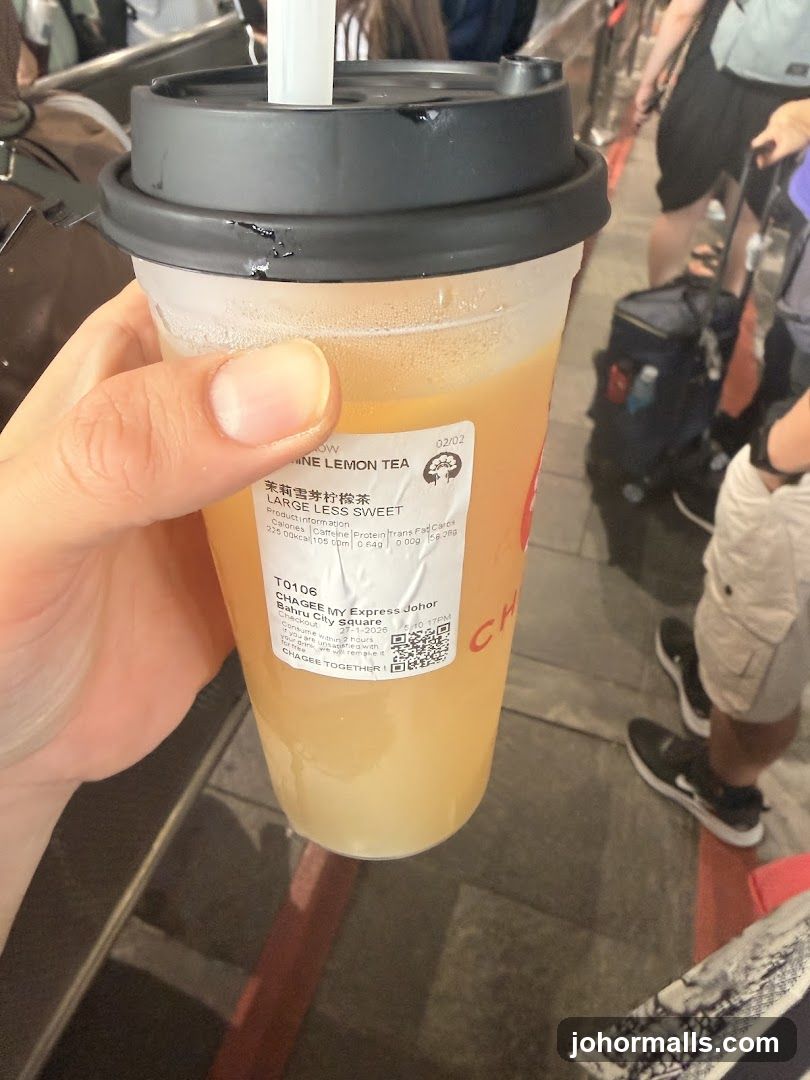 Hand holding a Chaee My Express drink