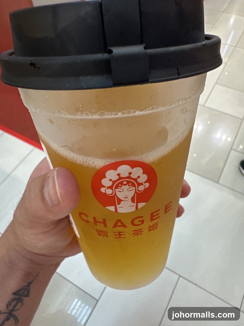 Hand holding Chagee drink