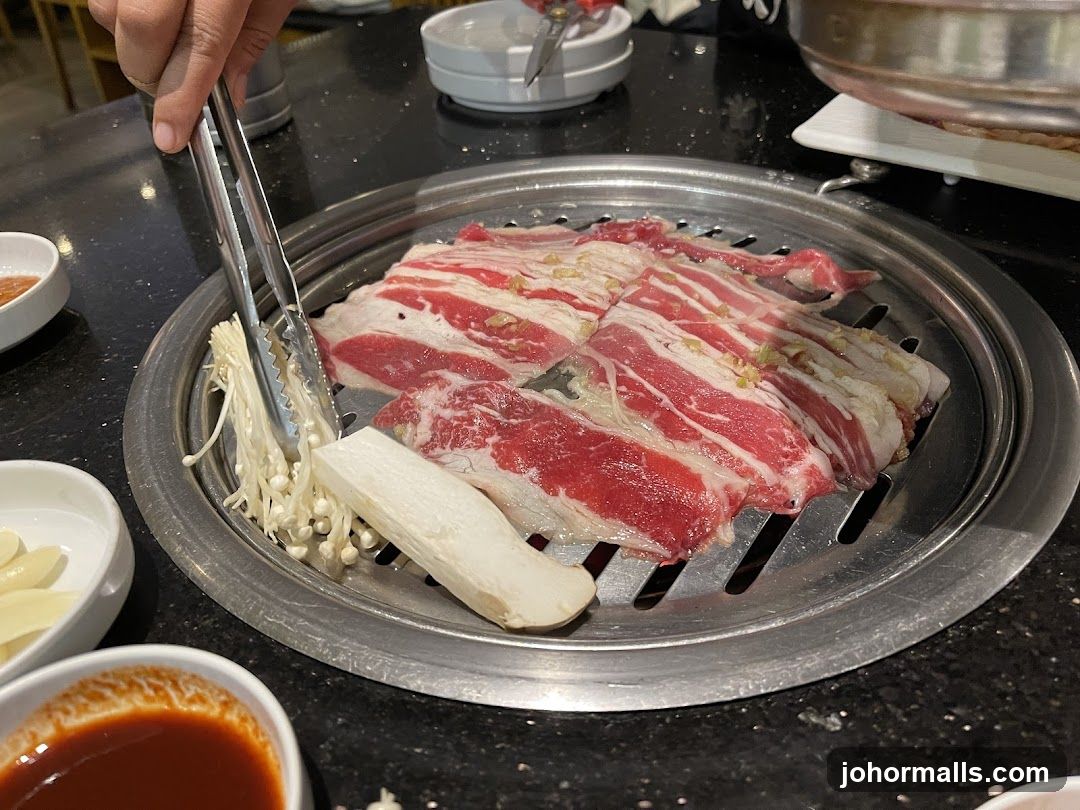 Grilled meat and vegetables on a Korean BBQ grill