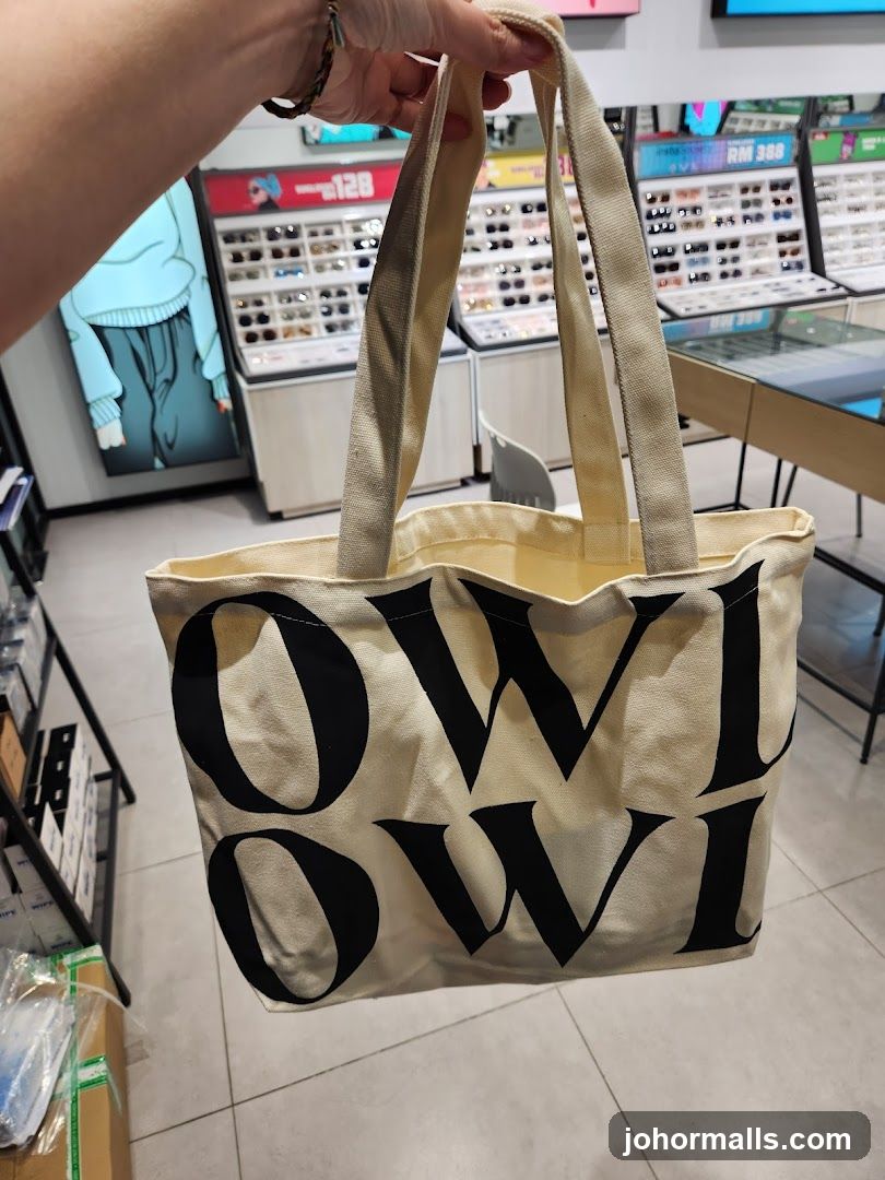 Hand holding tote bag in store