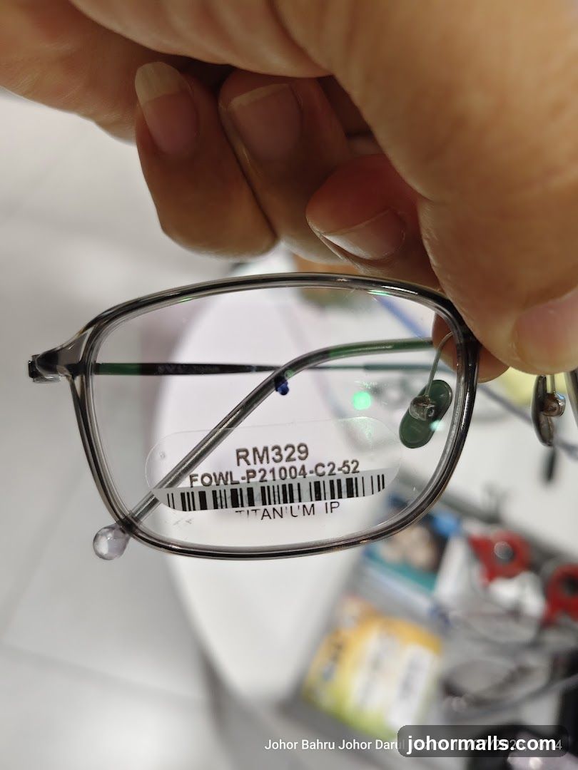 Hand holding eyeglasses