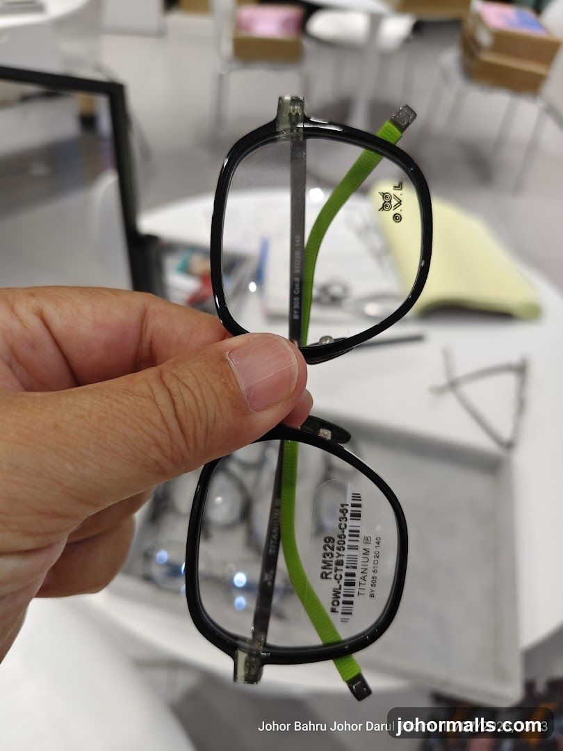 Hand holding eyeglasses in store