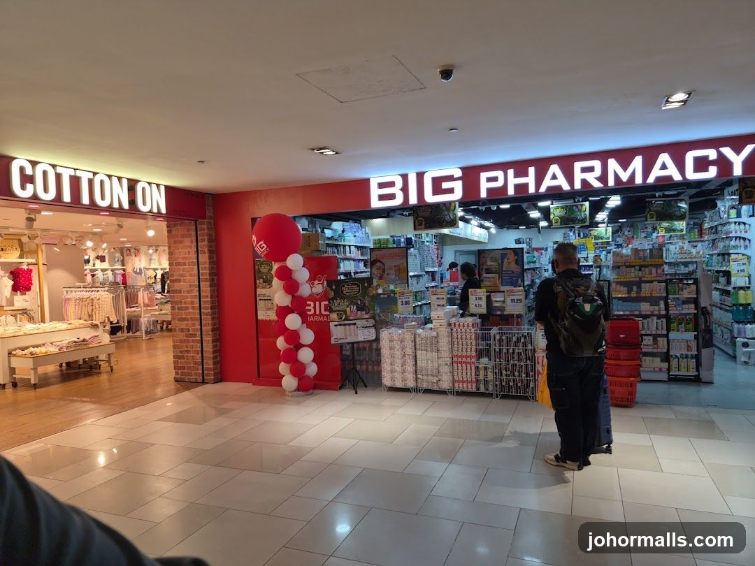 Interior of shopping mall with pharmacy and clothing store