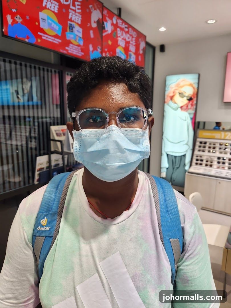 Person wearing glasses and mask in a store