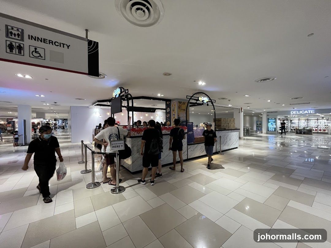 People queuing at a food stall in a mall