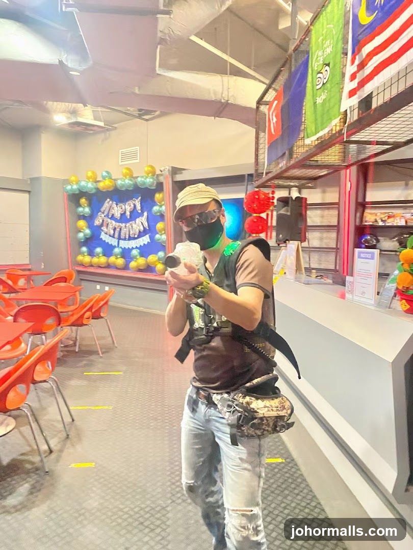 Man holding a laser tag gun