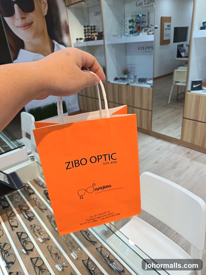 Orange shopping bag with Zibo Optic logo