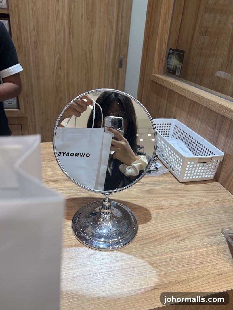 Woman taking a mirror selfie with a shopping bag