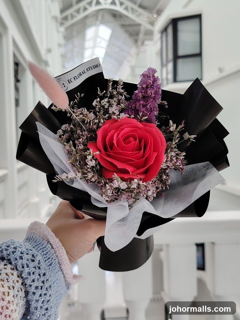 Hand holding a preserved rose bouquet