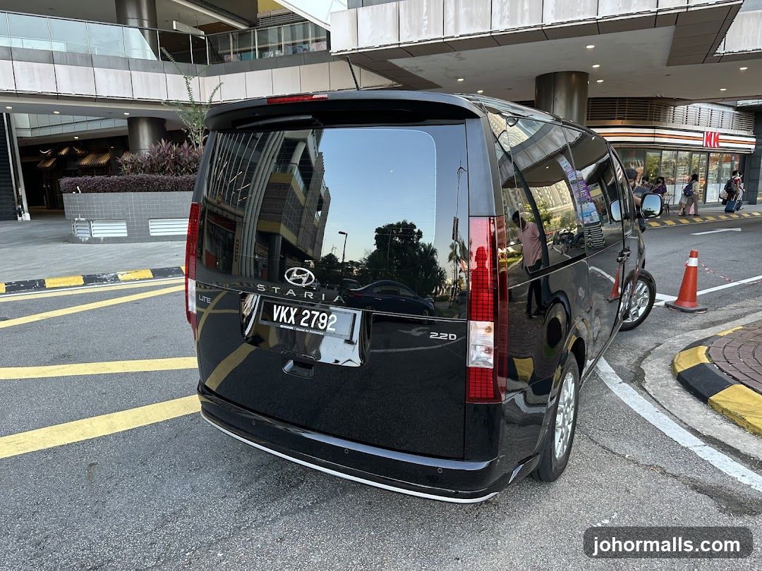 Black Hyundai Staria Van Parked Near a Storefront