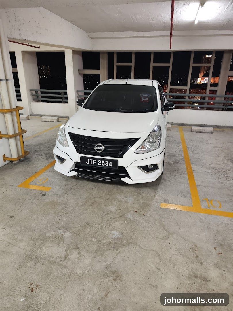 White Nissan Car in Parking Lot