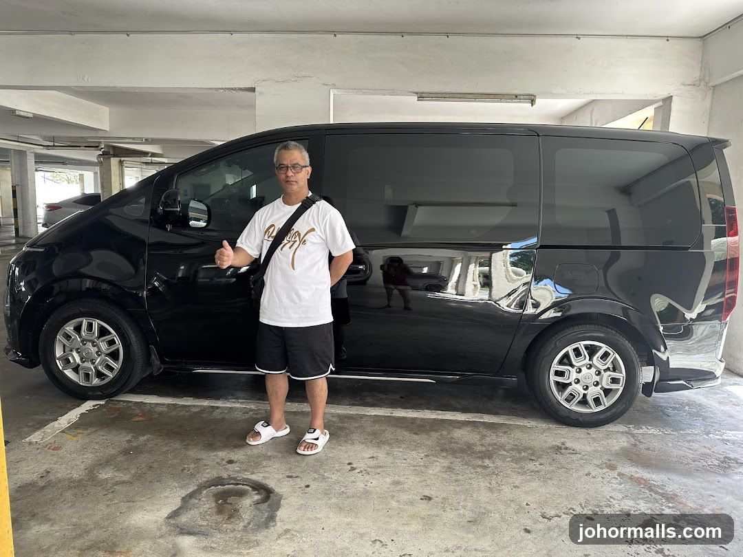Man posing with a black van