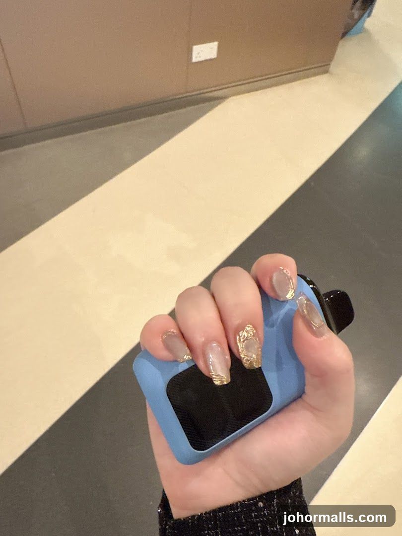 Hand holding a blue vape device