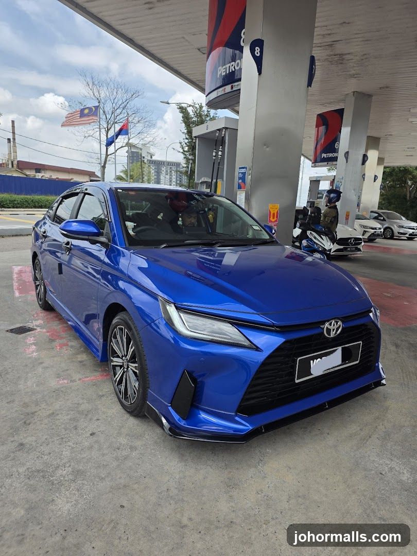 Blue car at a gas station