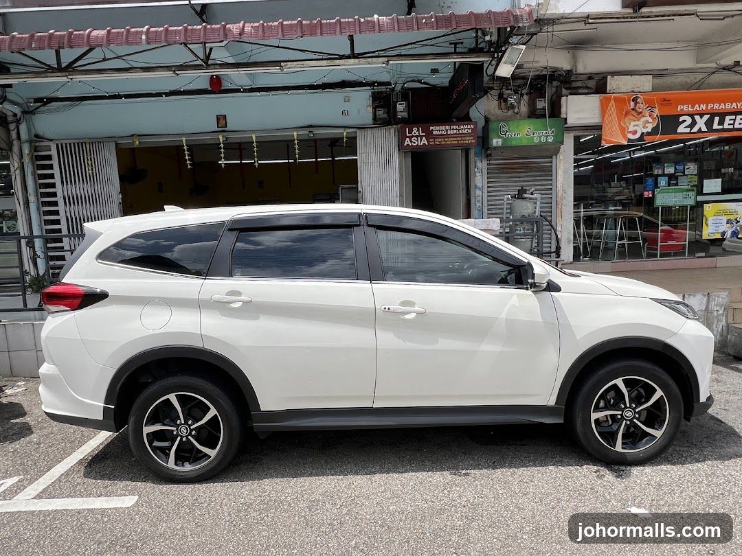 White SUV parked in front of shops