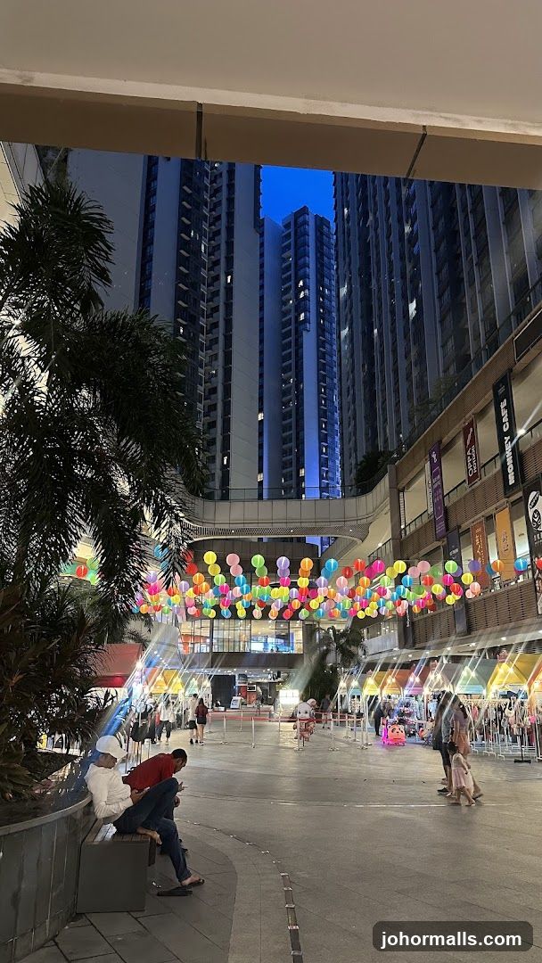Outdoor shopping area with lanterns and buildings