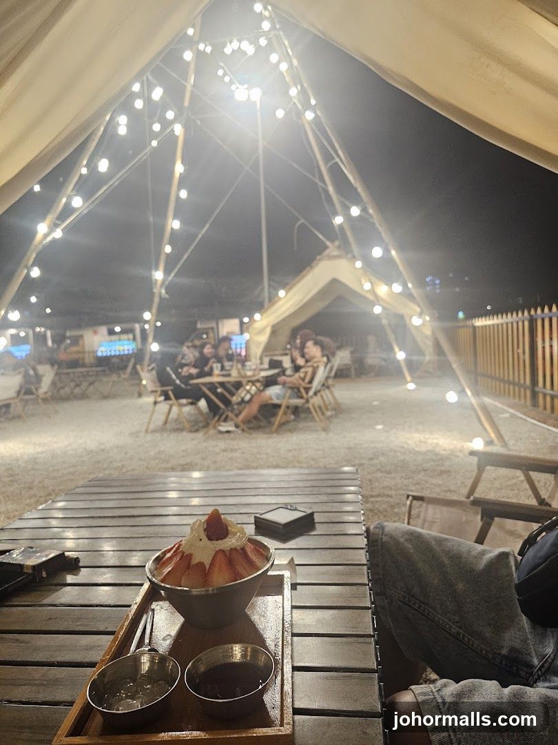 Outdoor dining area with string lights and dessert