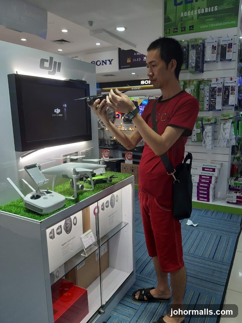 Man examining a drone in an electronics store