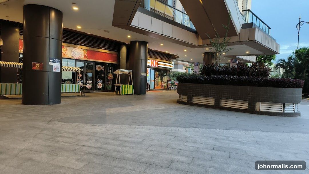 Outdoor walkway with shops and plants