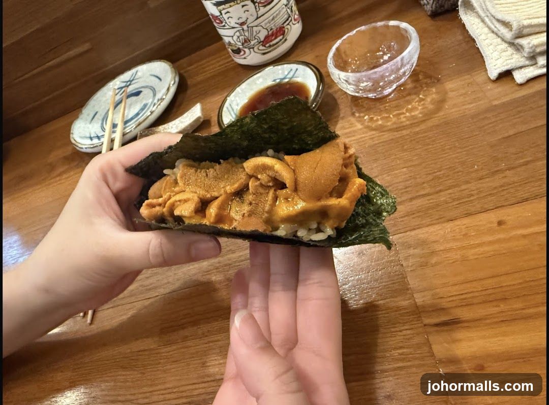 Hand holding Uni Hand Roll