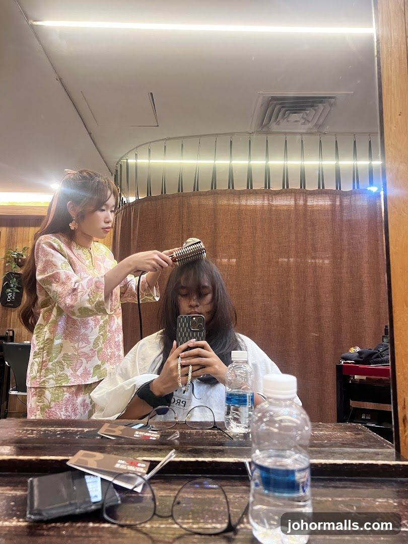 Hairdresser styling client's hair