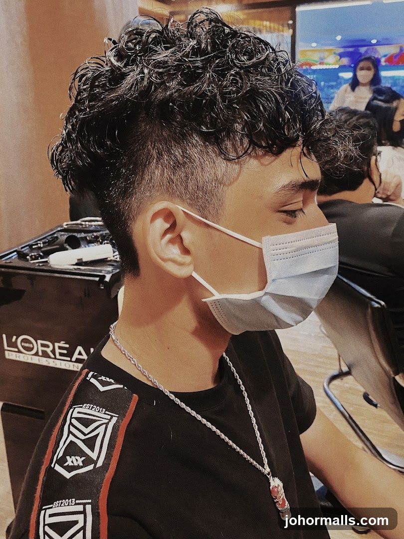 Man with curly hair and mask