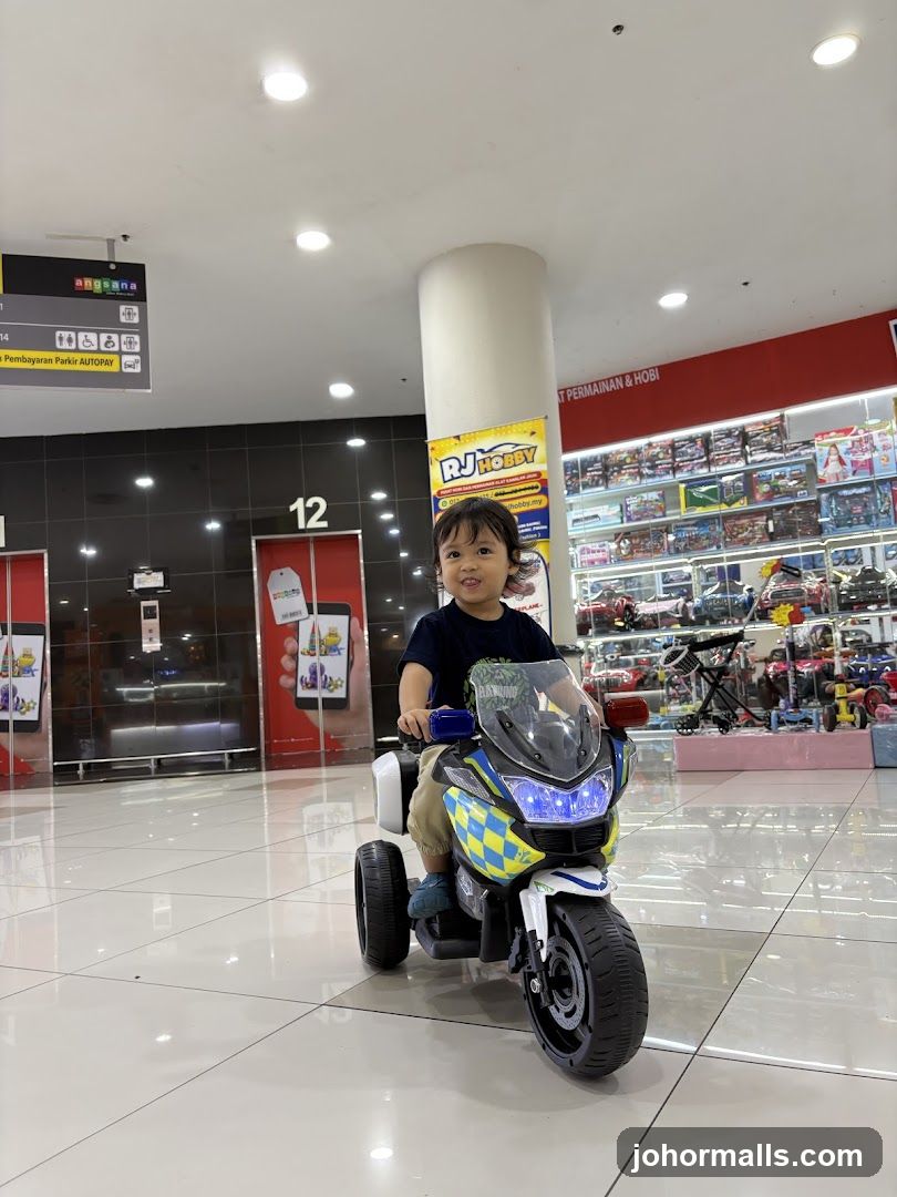 Child Riding a Toy Police Motorcycle in a Store