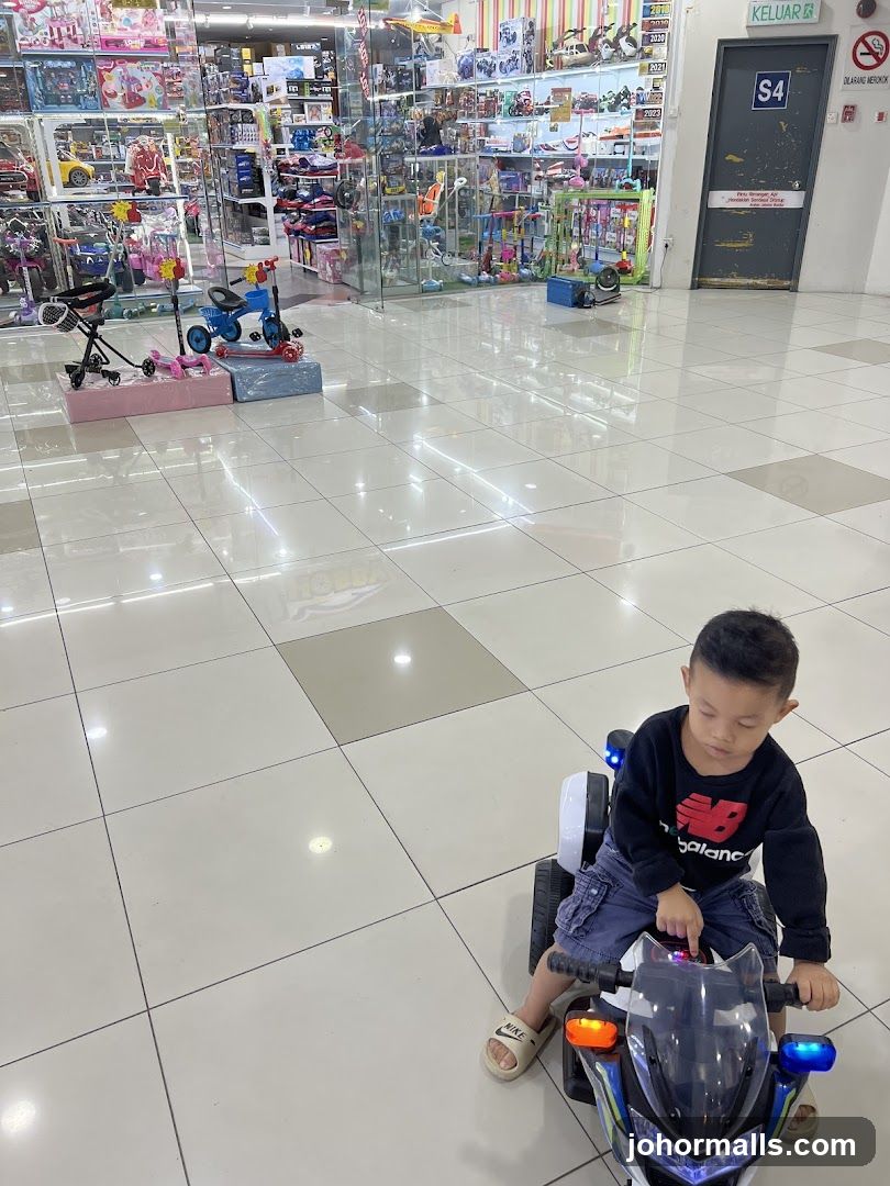 Boy Riding Toy Motorcycle in Toy Store