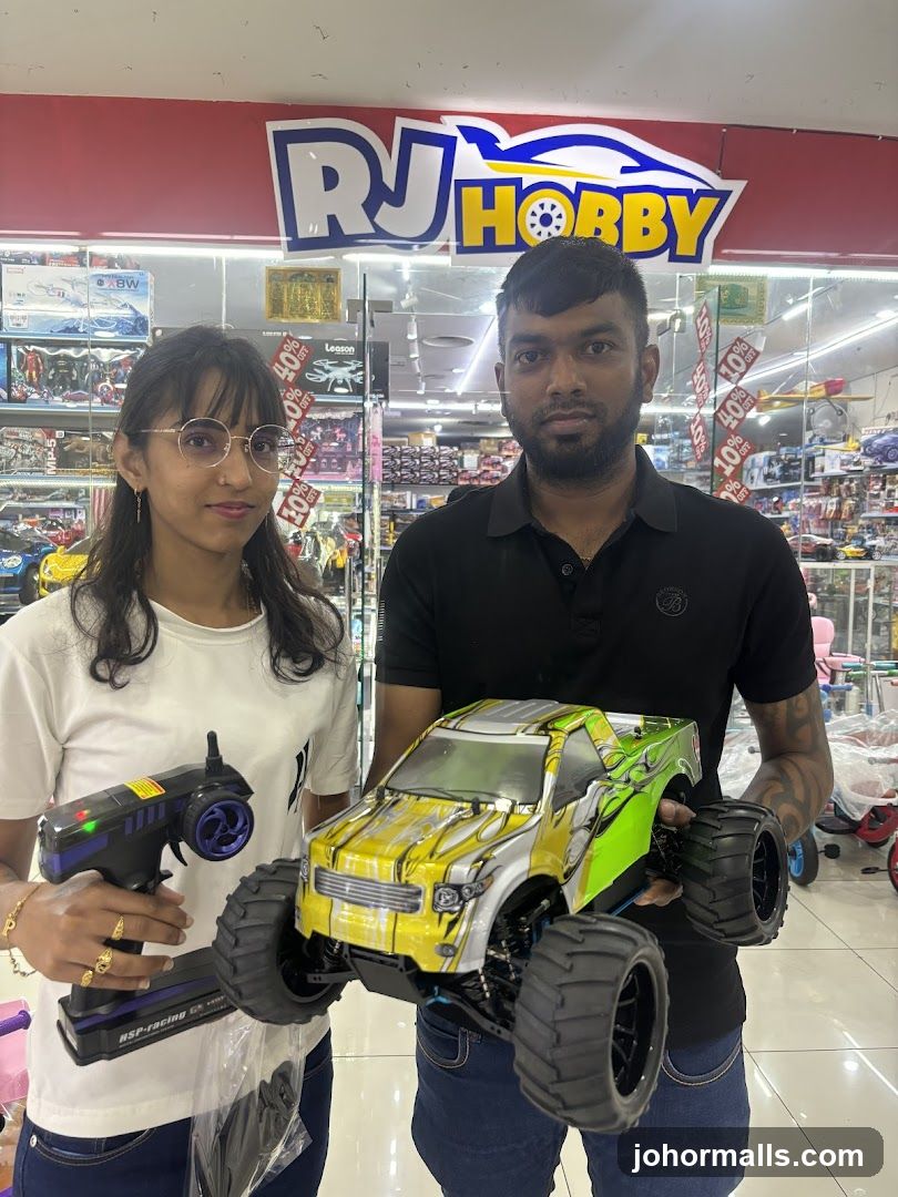 People holding a remote-controlled car and controller