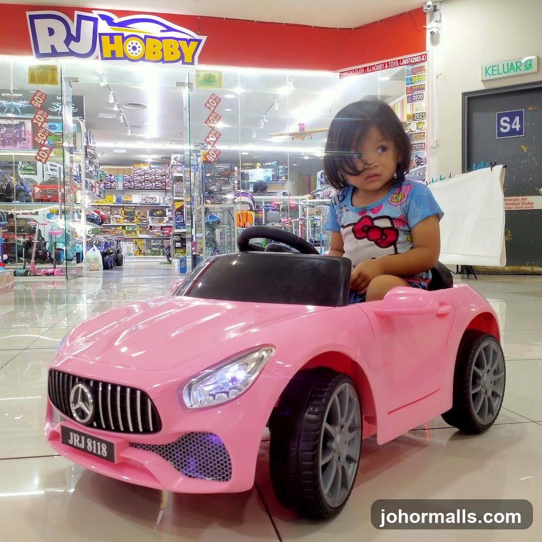 Child in a toy car at a hobby store