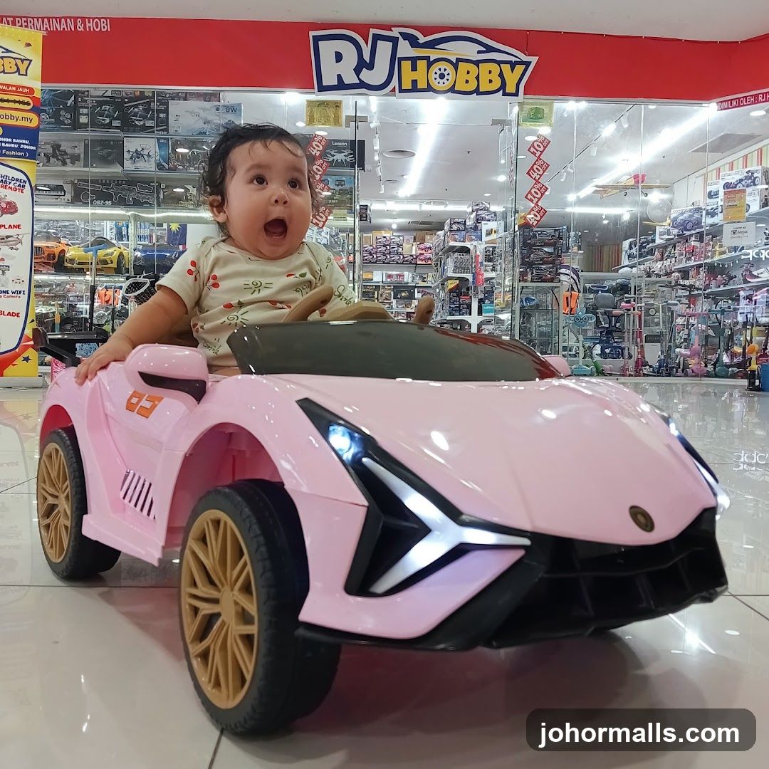 Baby in a toy car at RJ Hobby store
